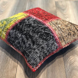 Handmade patchwork pillow with red pink stitches