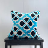 Velvet Ikat Cushion Flowers Turquoise on table