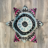Velvet Ikat Pillow Peace below another cushion