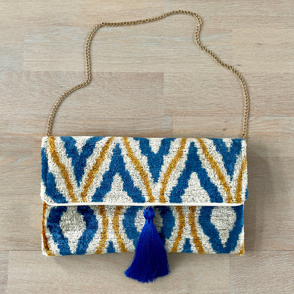 Vibrant blue and yellow clutch bag with blue tassel